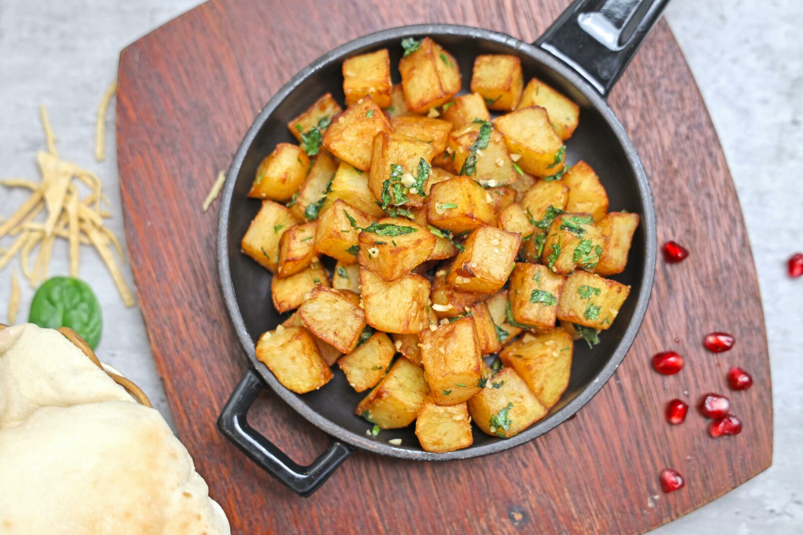 Crispy roasted potatoes with herbs in a cast iron skillet. Delicious Erntedankfest side dish.
