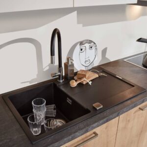 Moderne schwarze Spüle mit Armatur und Holzelementen in einer Küche